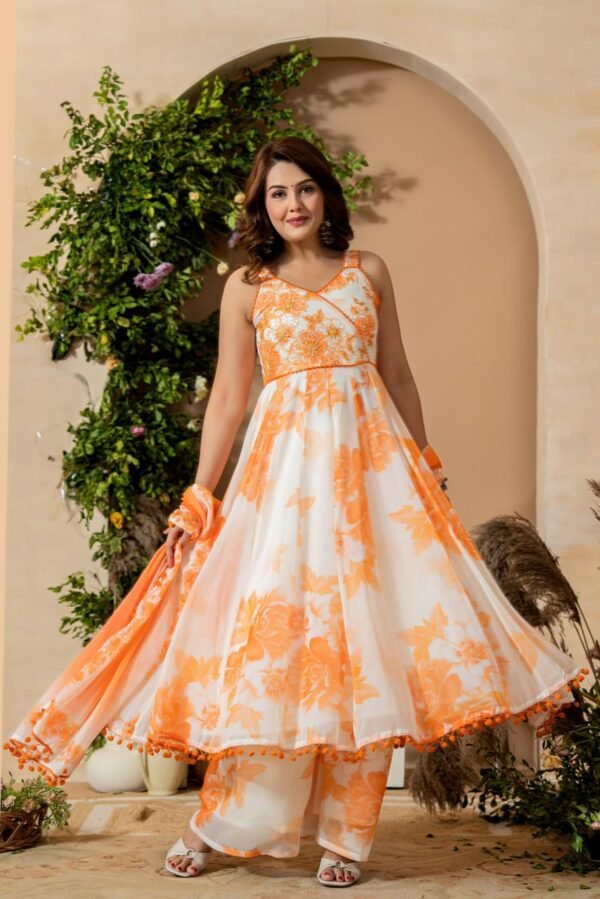 Anarkali suit set featuring a white base with prominent orange floral prints.