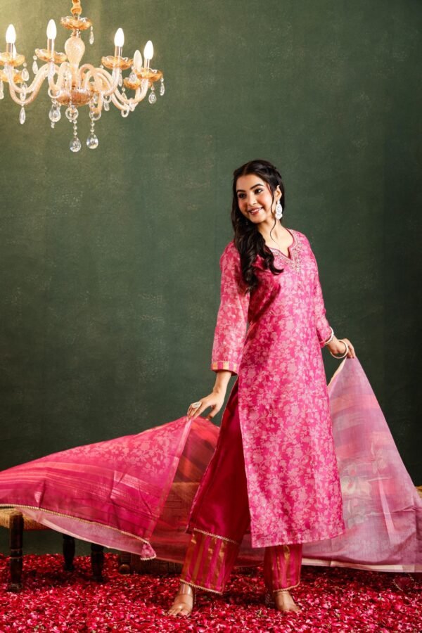 Pink ethnic ensemble, likely a kurta set, consisting of a kurta (tunic), matching pants or leggings, and a dupatta (scarf).